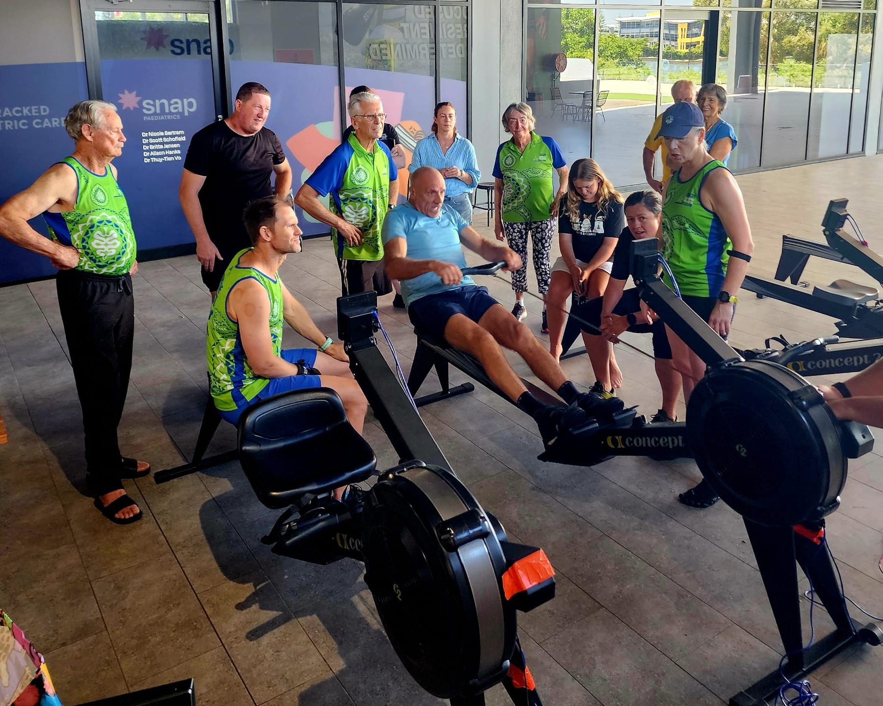Athletes racing head-to-head on Concept2 ergs while the community watches at an AIRC event