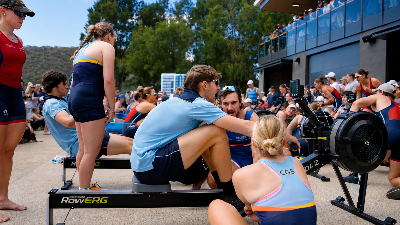 Athletes and crowds at an indoor rowing event, competitors racing on Concept2 RowErgs